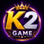 K2 Game logo featuring bold gold and silver K2 lettering, a crown, purple glow, and GAME banner on a dark background.